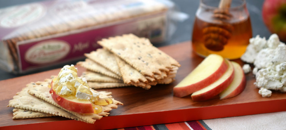 Multigrain Mini Croccantini on a cutting board with cheese and apple
