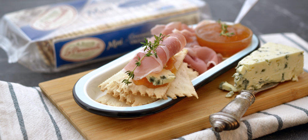 Original Mini Croccantini on a cutting board with meat and cheese